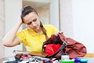 Woman searching her purse to find lost Invisalign aligner