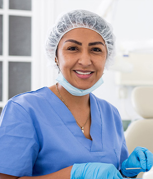 Three dental team members laughing together