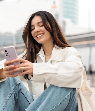 Smiling lady reads something on phone