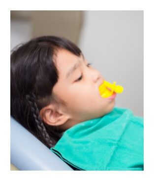 Child receiving fluoride treatment