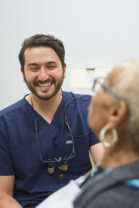 Woman pointing to smile after cosmetic dentistry