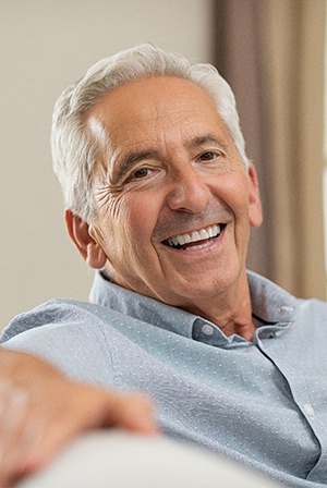 man smiling after getting dentures 