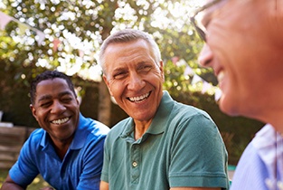 mature man happily talking to friends 