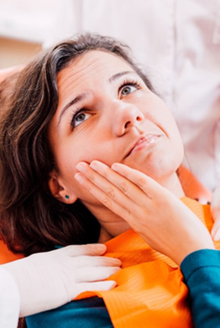 Woman in the dental chair with a toothache