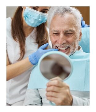 Man looking at his smile in a mirror