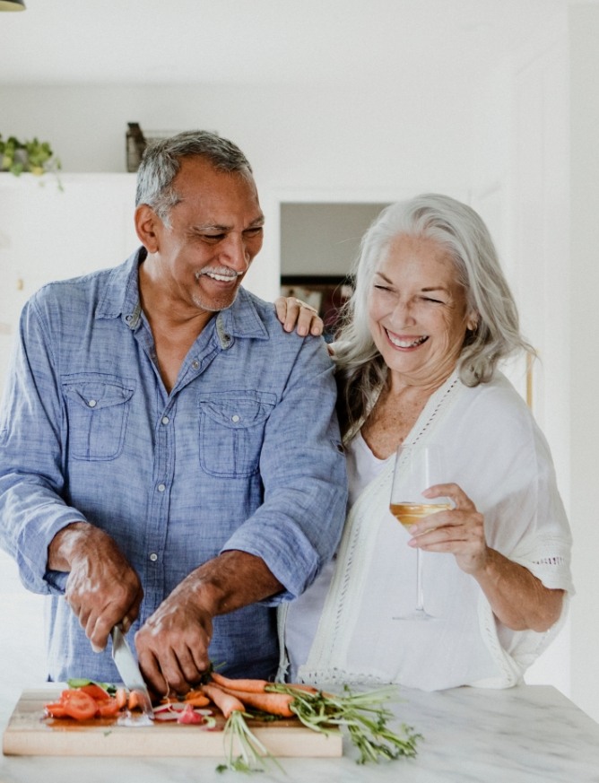 Man and woman with healthy smiles after restorative dentistry