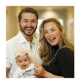 Dentist and dental team member smiling together