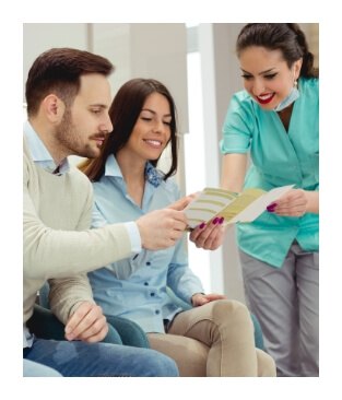 Dental team member reviewing dental insurance forms with dentistry team members