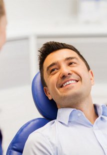 Woman sitting in dental chair in Corrales  