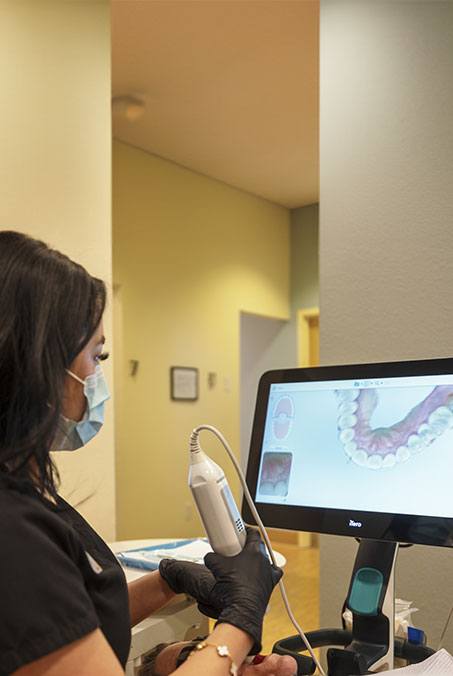 Woman placing clear braces orthodontics tray