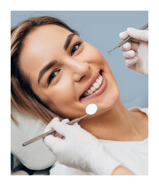Smiling woman receiving dental checkup and teeth cleaning