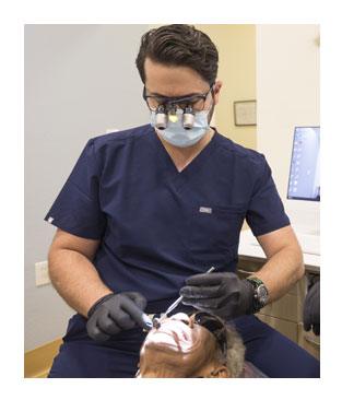 Smiling woman receiving dental checkup and teeth cleaning