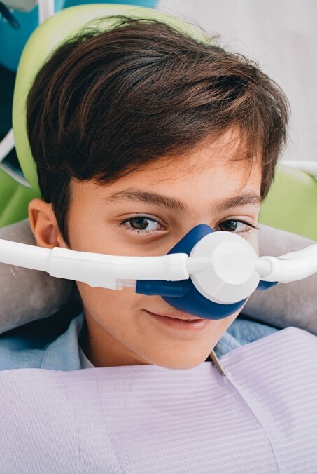 Young dental patient receiving sedation dentistry treatment