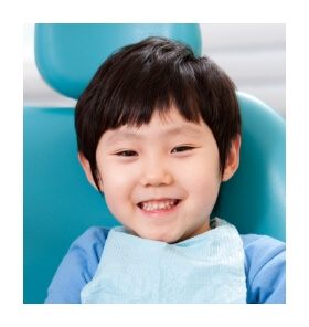 Child smiling in dental chair for children's dentistry