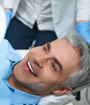 a person smiling after getting dental veneers