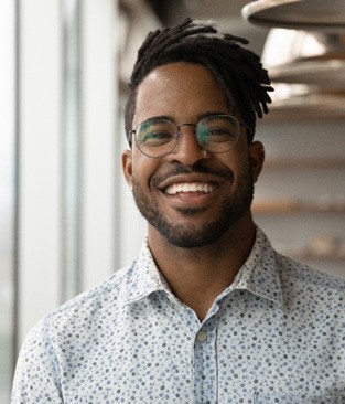 a smiling person standing in an office