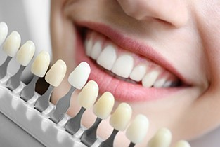 Patient and dental assistant smiling at each other