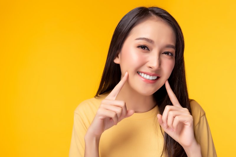 young woman smiling after fixing her small teeth