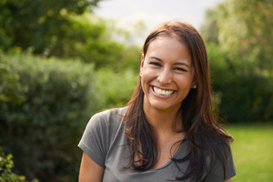 Woman standing outside in a field smiling